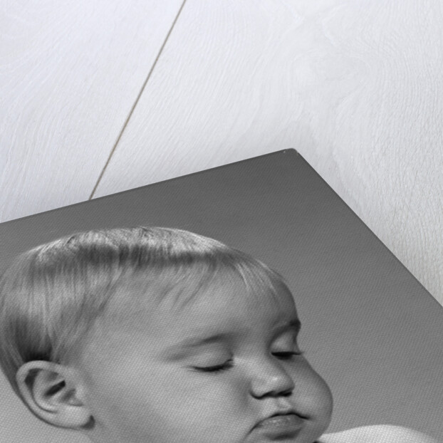 1960s portrait baby nodding off to sleep by Anonymous