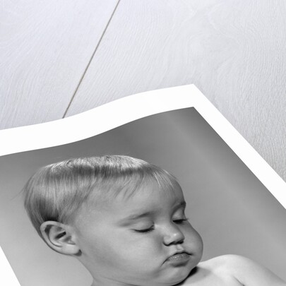 1960s portrait baby nodding off to sleep by Anonymous