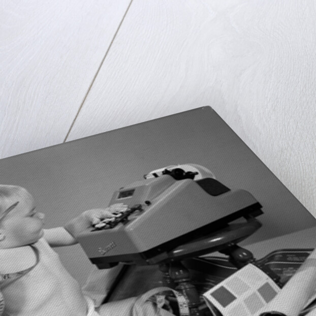 1960s baby with adding machine telephone blueprints paint samples and tape measure by Anonymous