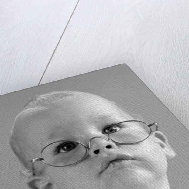 1960s baby wearing wire-rimmed granny glasses by Anonymous