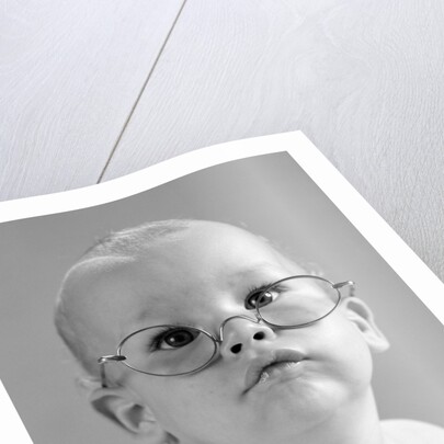 1960s baby wearing wire-rimmed granny glasses by Anonymous