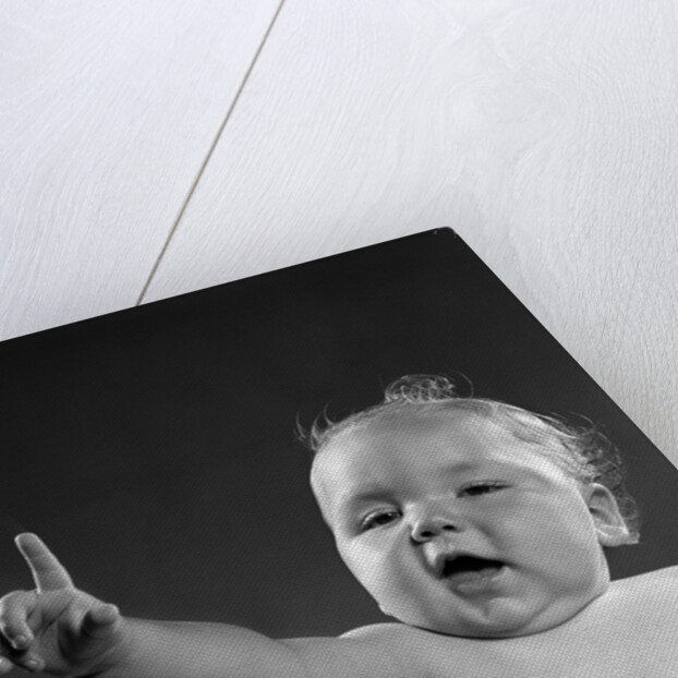 1940s 1950s baby sitting in chair arm and one finger raised objecting voting making a point looking at camera by Anonymous