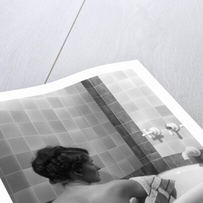 1920s 1930s young brunette woman sitting in luxury bathtub taking a bath by Anonymous