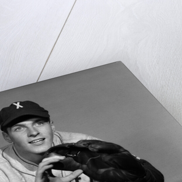 1950s baseball player with glove poised to catch ball keeping his eye on the ball by Anonymous