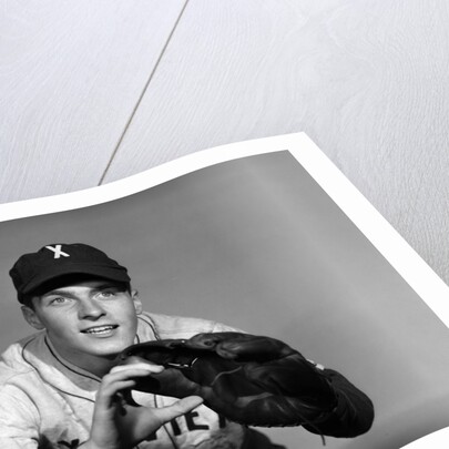 1950s baseball player with glove poised to catch ball keeping his eye on the ball by Anonymous
