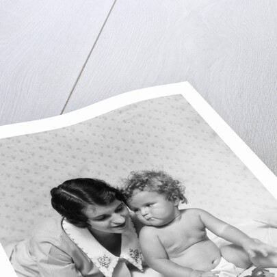 1920s 1930s woman mother lying sitting with baby on blanket by Anonymous