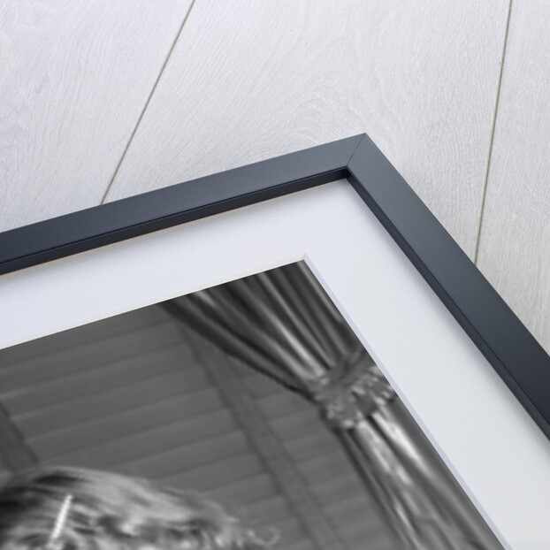 1950s little blond girl in pajamas standing at bathroom sink brushing her teeth toothpaste and toothbrush in hand by Anonymous