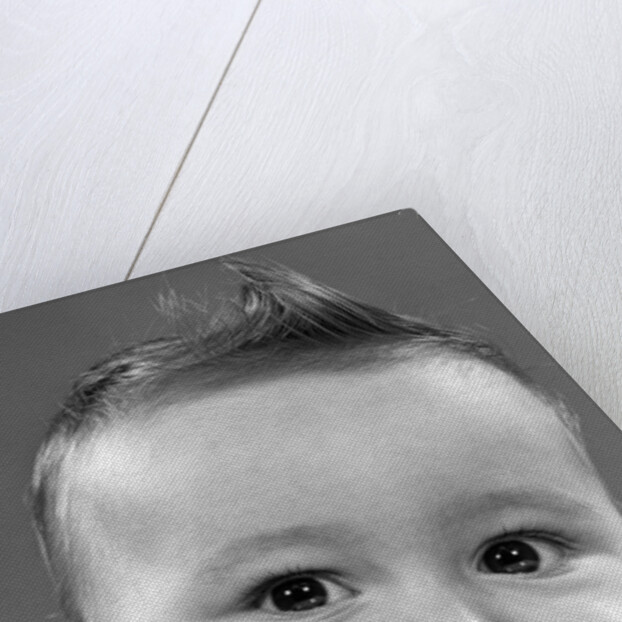 1950s baby making a funny face and bronx cheer noise looking at camera by Anonymous