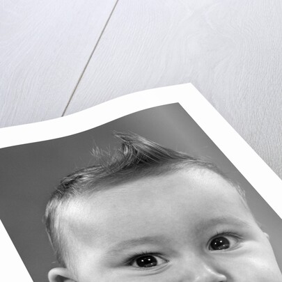 1950s baby making a funny face and bronx cheer noise looking at camera by Anonymous