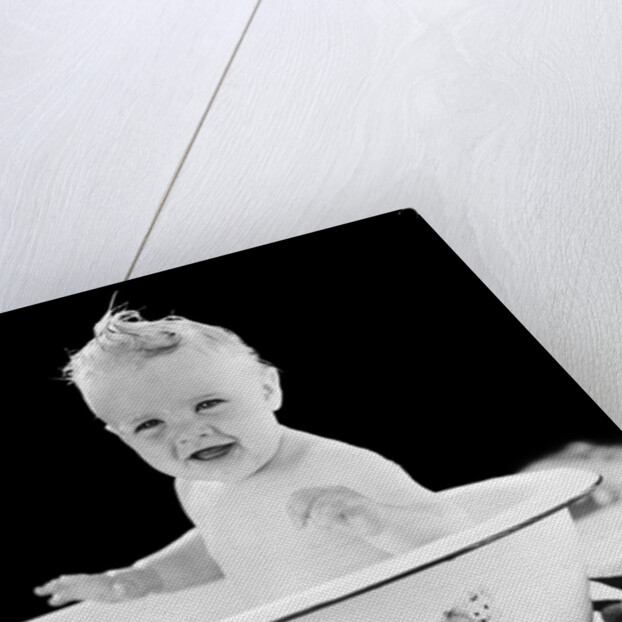 1930s 1940s smiling happy baby sitting in enameled tin bathtub by Anonymous