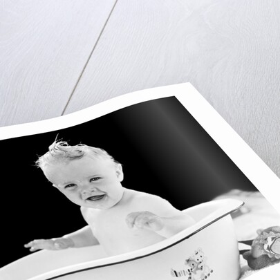 1930s 1940s smiling happy baby sitting in enameled tin bathtub by Anonymous