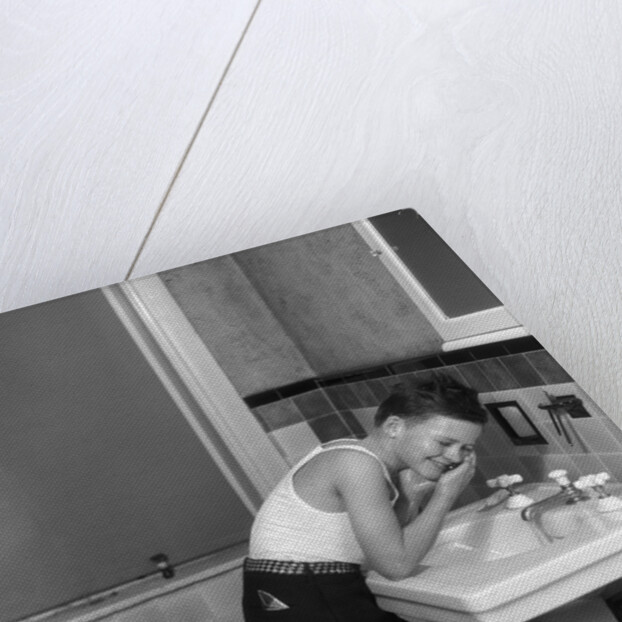 1930s boy washing face at bathroom sink by Anonymous