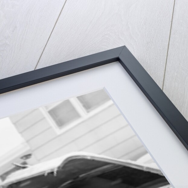 1950s man winter driveway trying to start fix car hood up by Anonymous