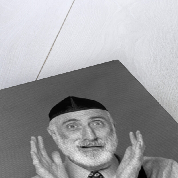 1990s character portrait man gray beard wearing yarmulke hebrew jewish skullcap hands up to face gesture funny expression oy looking at camera by Anonymous