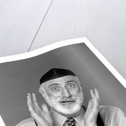 1990s character portrait man gray beard wearing yarmulke hebrew jewish skullcap hands up to face gesture funny expression oy looking at camera by Anonymous