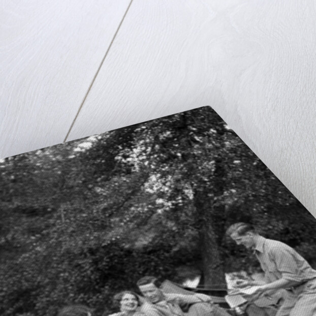 1920s four people two couples men women sitting on ground enjoying a picnic by Anonymous