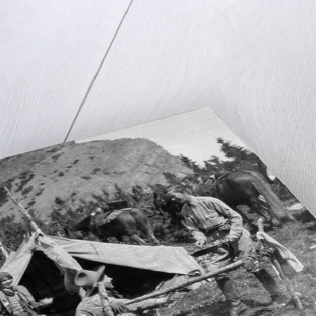 1920s 1930s two men and one woman eating a meal around a campfire with a tent and horses at baker lake alberta canada by Anonymous