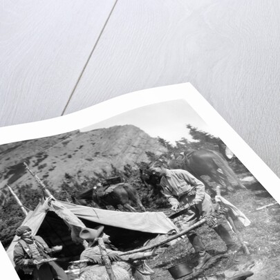 1920s 1930s two men and one woman eating a meal around a campfire with a tent and horses at baker lake alberta canada by Anonymous