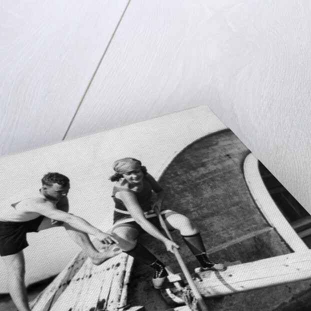 1920s man and woman in bathing suits crabbing off old abandoned wooden boat by Anonymous