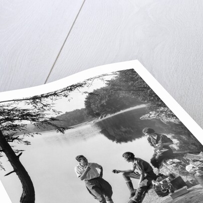 1920s 1930s 3 people picnicking by onata lake man wearing jodhpurs standing two seated women berkshires ma usa by Anonymous