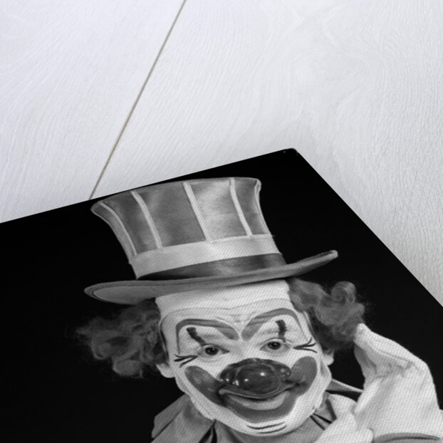 1950s portrait of clown wearing top hat smiling looking at camera by Anonymous