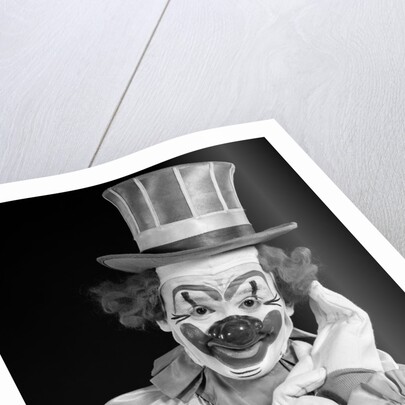 1950s portrait of clown wearing top hat smiling looking at camera by Anonymous