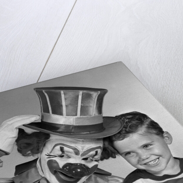 1950s smiling clown with top hat arm around grinning boy in striped shirt by Anonymous