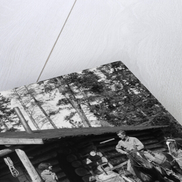1920s 1930s couple in front of log cabin woman sitting on porch railing man on horse alberta canada by Anonymous