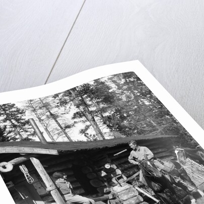 1920s 1930s couple in front of log cabin woman sitting on porch railing man on horse alberta canada by Anonymous