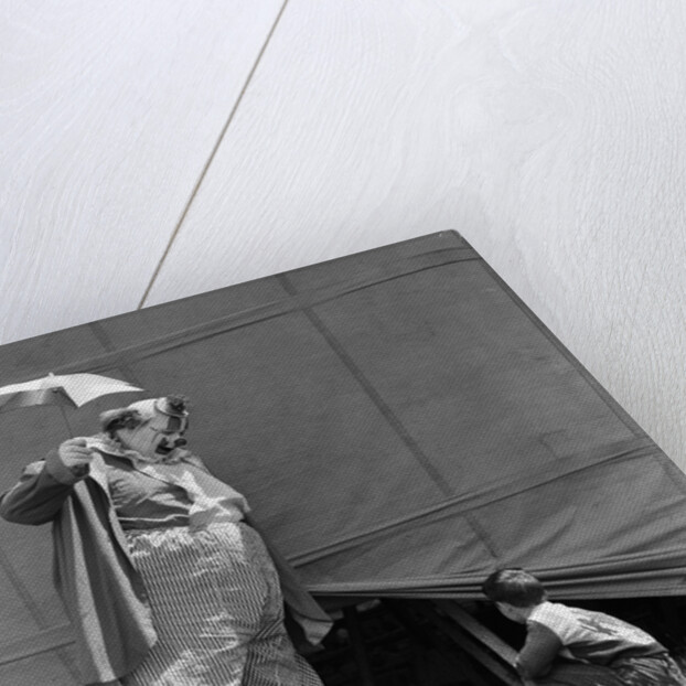 1930s man clown catching little boy peeking under circus big top tent by Anonymous