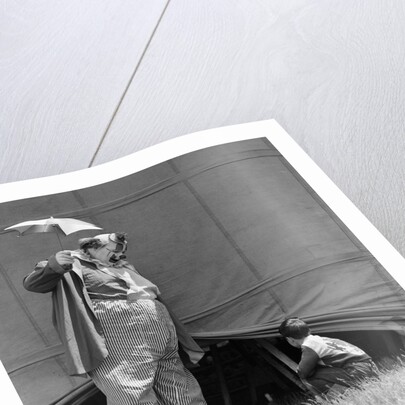 1930s man clown catching little boy peeking under circus big top tent by Anonymous