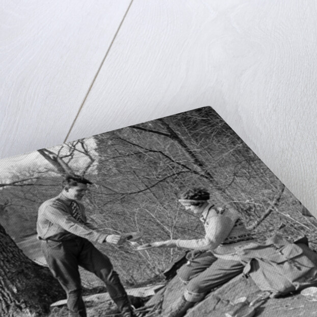 1920s 1930s man & woman camping by lake having picnic woman sitting man standing serving food to woman east creek swamp by Anonymous