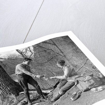 1920s 1930s man & woman camping by lake having picnic woman sitting man standing serving food to woman east creek swamp by Anonymous