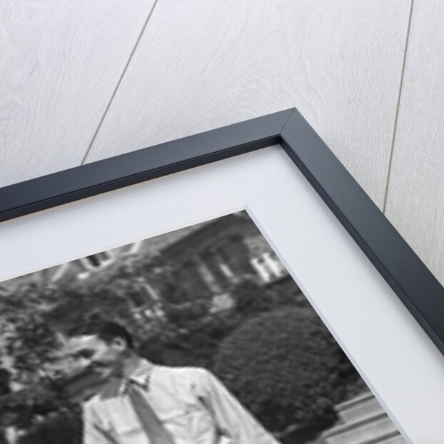 1930s family of four getting into convertible automobile with picnic basket and thermos jug by Anonymous