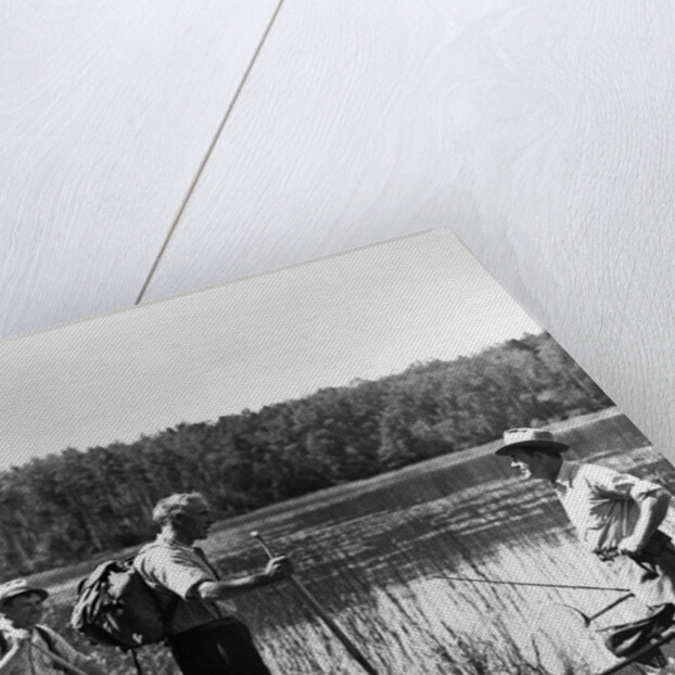 1930s three fishermen standing beside canoe holding fishing gear net backpack lake of the woods ontario by Anonymous