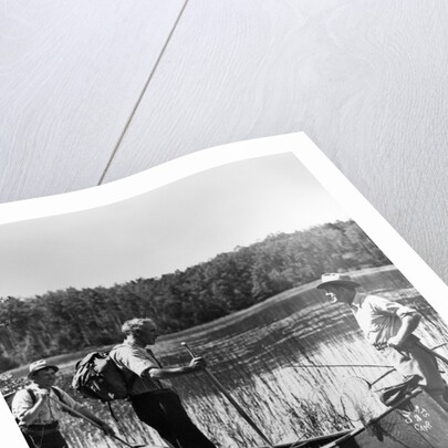 1930s three fishermen standing beside canoe holding fishing gear net backpack lake of the woods ontario by Anonymous
