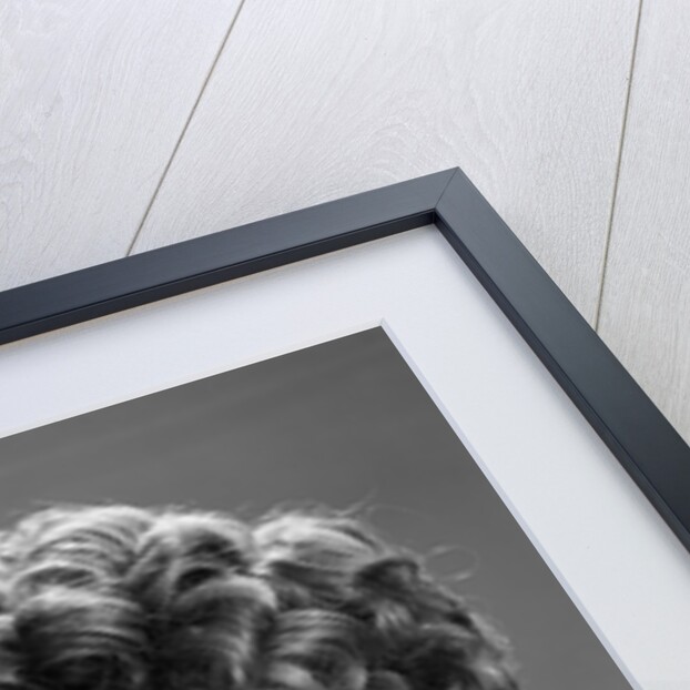 1960s glamorous woman with curly hair and dangling earrings smiling holding a champagne glass looking at camera by Anonymous