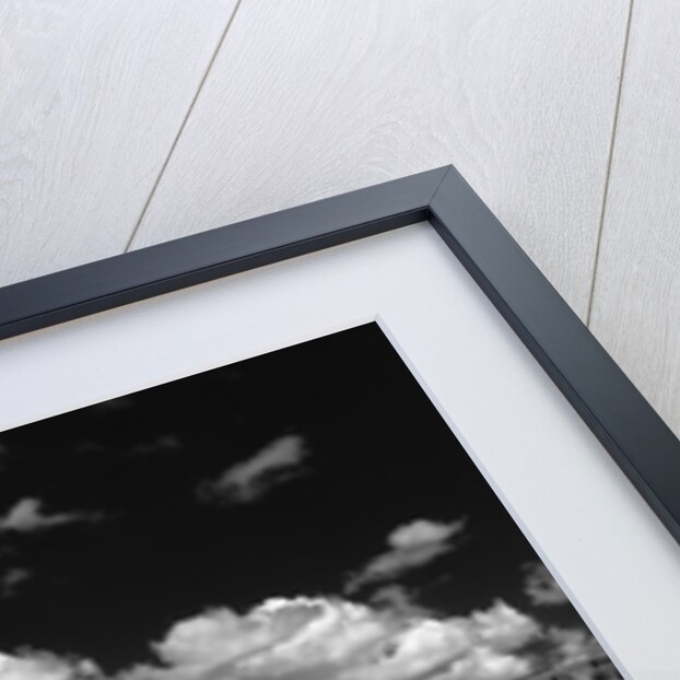 1950s farm scene with stacks of harvested wheat sky with puffy clouds by Anonymous
