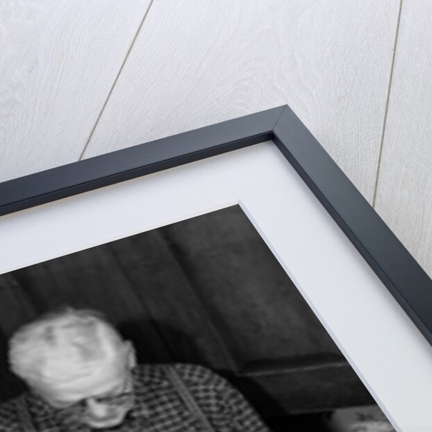 1950s 1960s little girl look at turkey sitting between grandmother grandfather saying grace at table by Anonymous