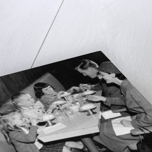 1950s family eating ice cream at a diner by Anonymous