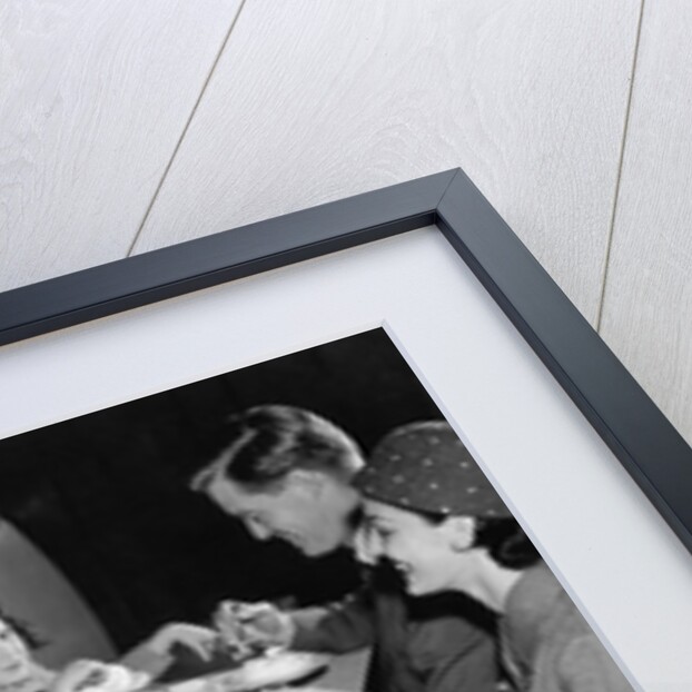 1950s family eating ice cream at a diner by Anonymous