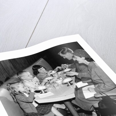 1950s family eating ice cream at a diner by Anonymous
