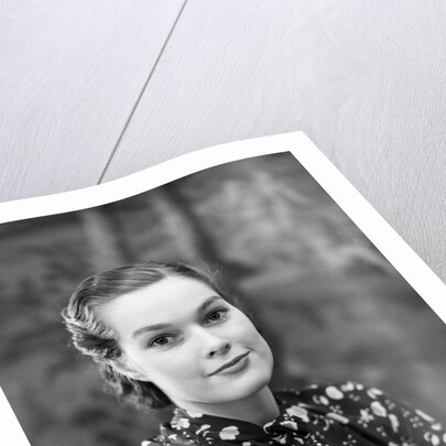1930s portrait of brunette woman wearing printed blouse half smile mona lisa like beautiful eyes looking at camera by Anonymous