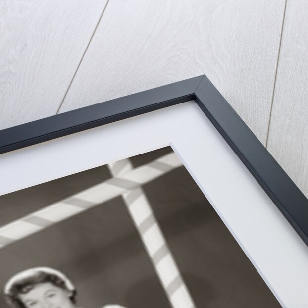 1950s 1960s woman in sexy football costume at goalpost by Anonymous