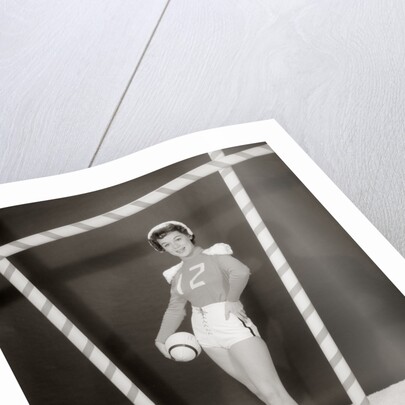 1950s 1960s woman in sexy football costume at goalpost by Anonymous