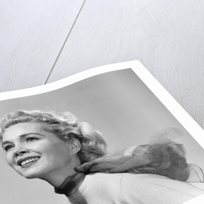 1950s 3/4 profile portrait smiling blond woman with wind blown hair and scarf by Anonymous