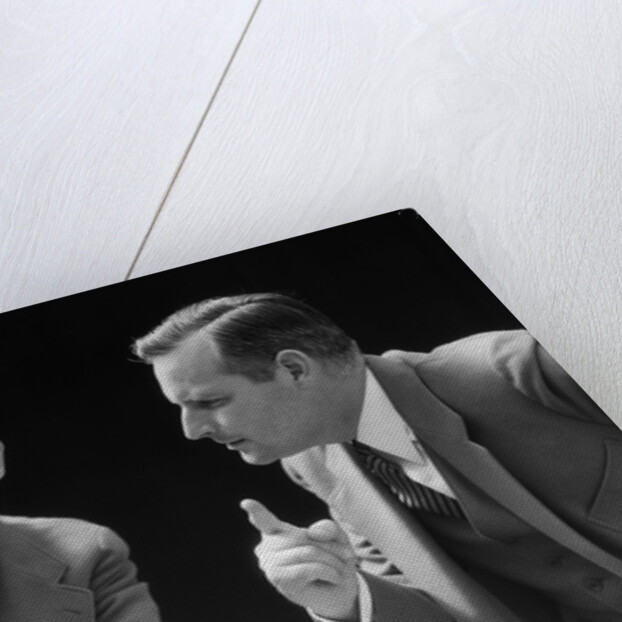 1930s 1940s businessman talking seriously to himself or his twin alter ego by Anonymous