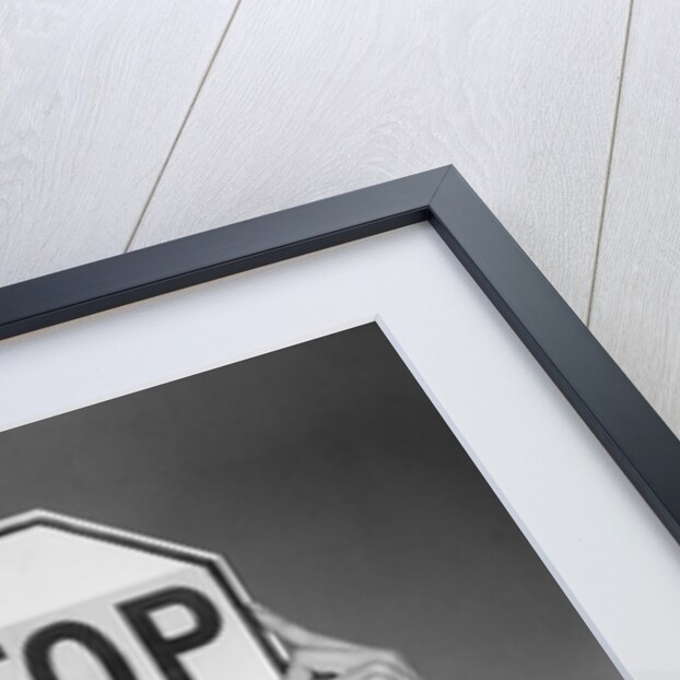 1950s 1960s smiling woman holding stop sign above her head looking at camera by Anonymous