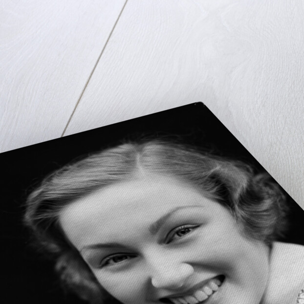 1930s portrait happy young brunette woman wearing print blouse with white collar smiling looking at camera by Anonymous