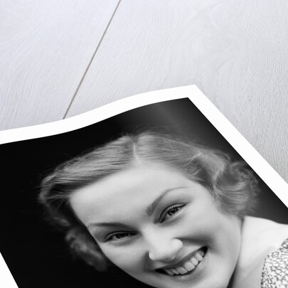 1930s portrait happy young brunette woman wearing print blouse with white collar smiling looking at camera by Anonymous